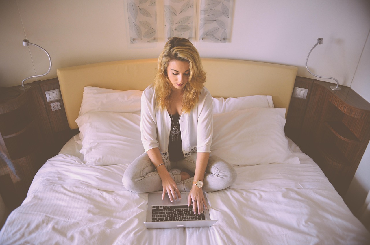Woman, working, bed — Construction project management tools that accelerate decisions